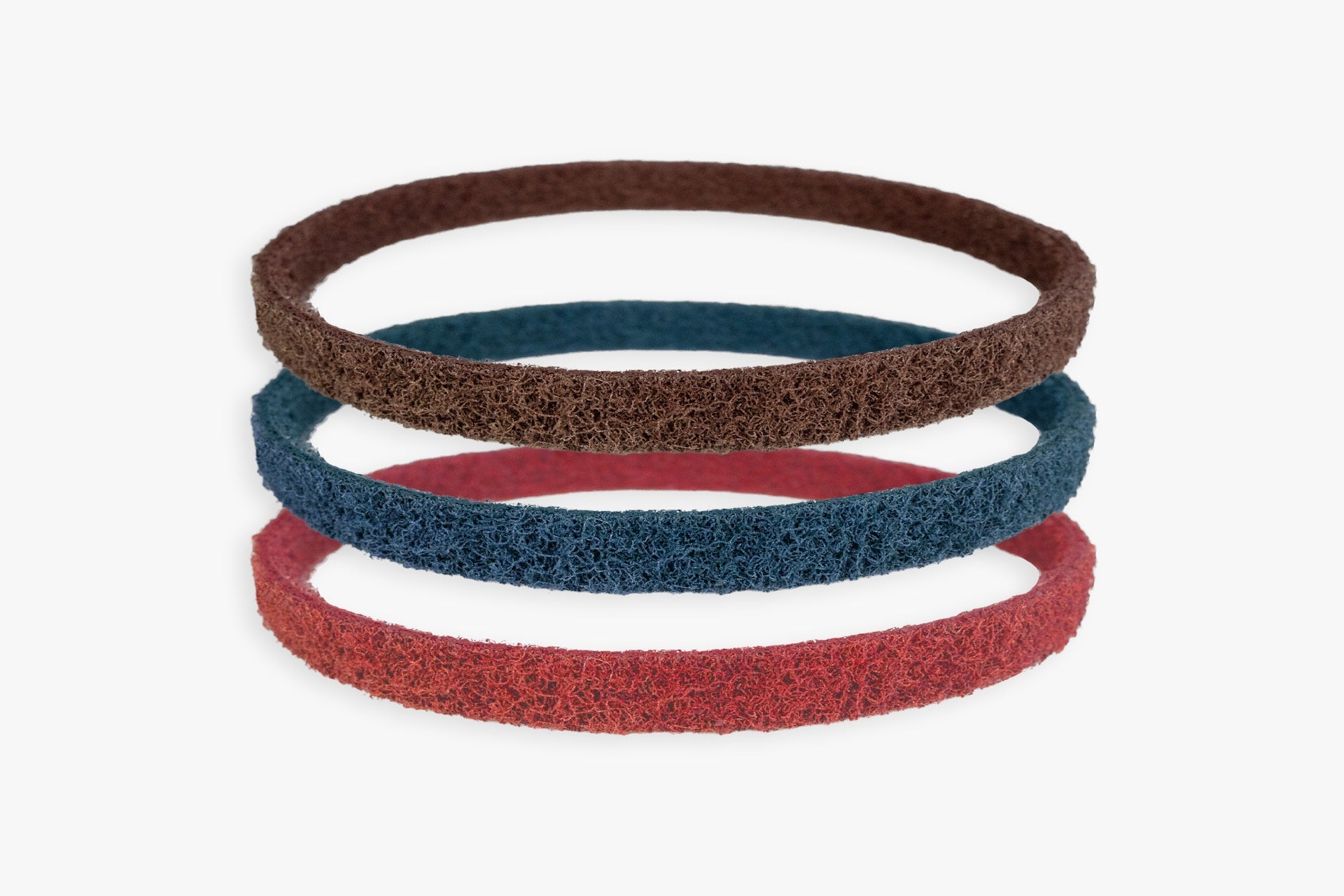 Kovax Scotchbrite abrasive belts, red blue and brown, stacked