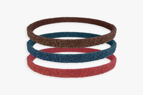 Kovax Scotchbrite abrasive belts, red blue and brown, stacked