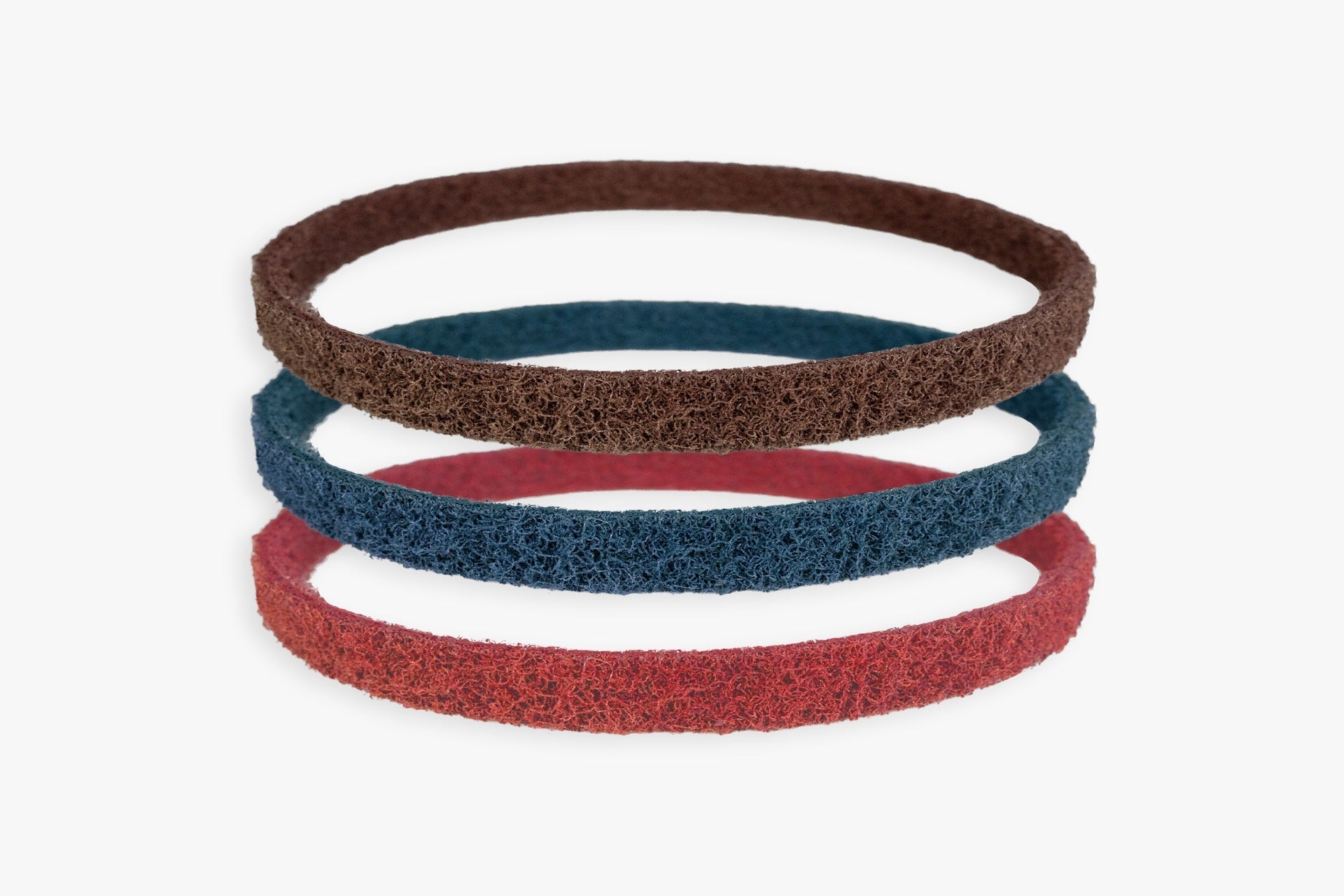 Kovax Scotchbrite abrasive belts, red blue and brown, stacked